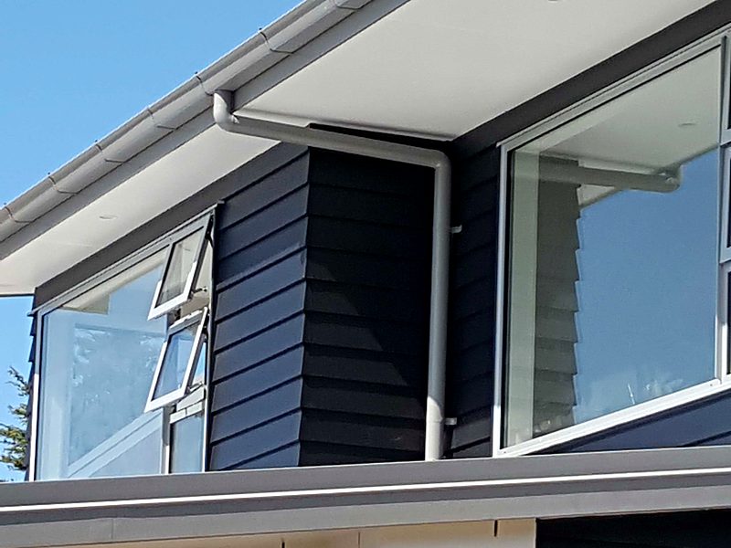 New spouting and downpipe on a modern dark-clad home